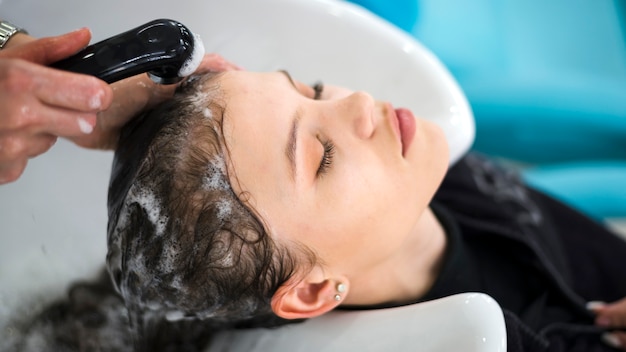 Brunette woman getting her hair washed