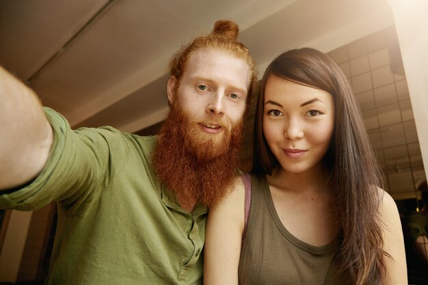 Brunette woman and ginger man sitting in cafe