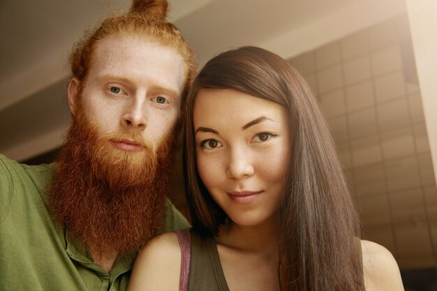 Brunette woman and ginger man sitting in cafe