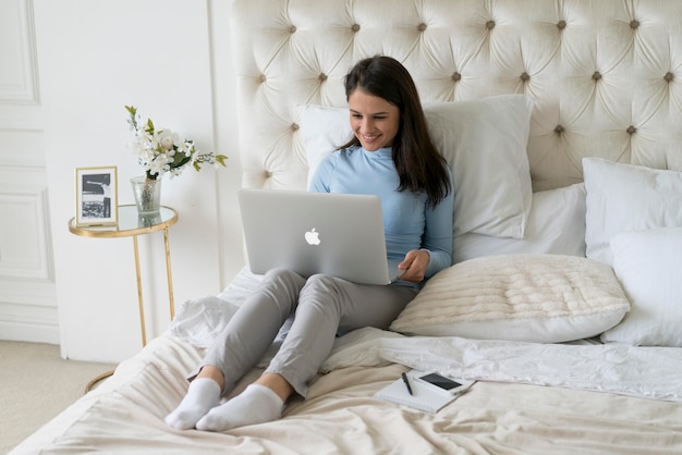 Brunette woman having a video call at home