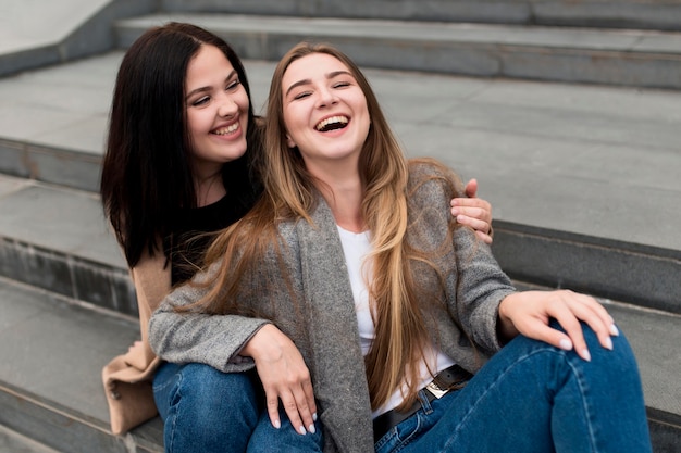 Brunette woman holding her smiley friend