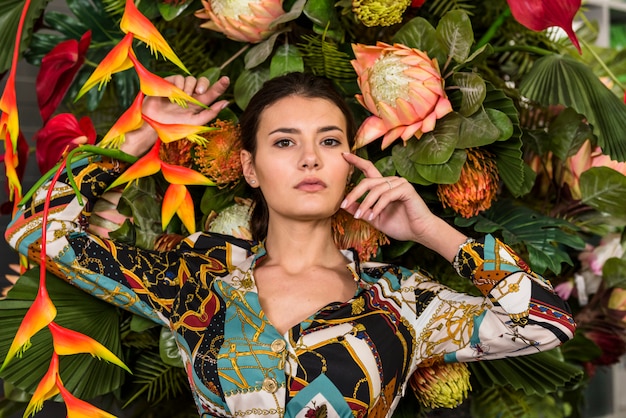 Brunette woman posing in green house