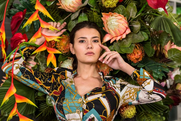 Brunette woman posing in green house