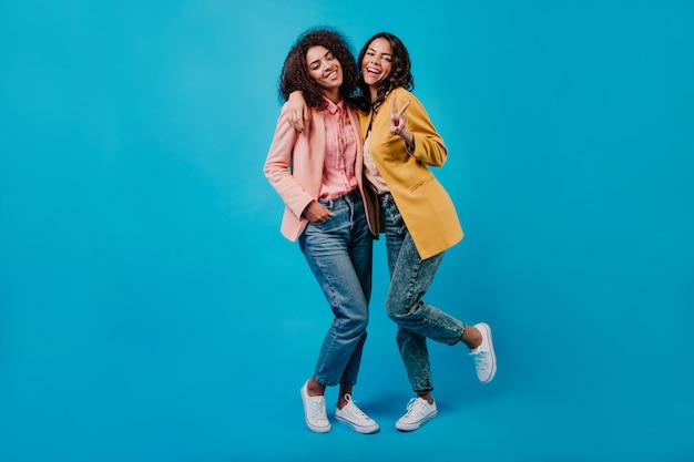 Brunette woman posing in studio with friend