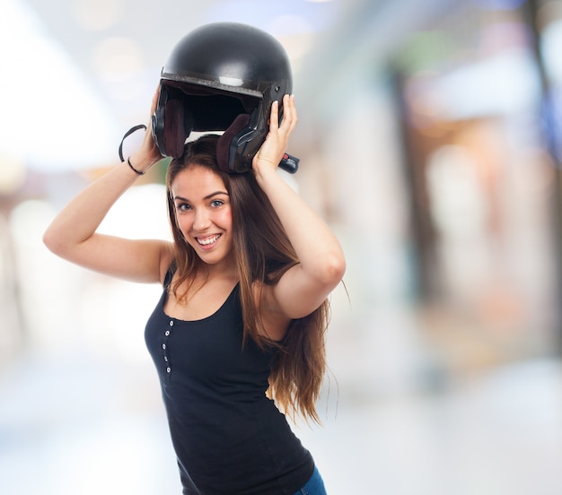 Brunette woman posing with protection helmet.