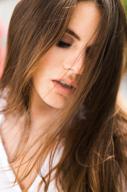 Brunette woman smokes a cigar