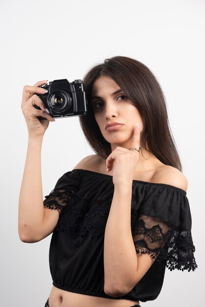 Brunette woman taking pictures with camera