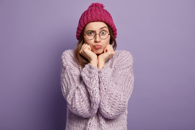 Brunette woman wearing knitted sweater and hat