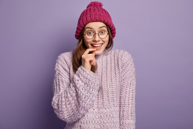 Brunette woman wearing knitted sweater and hat