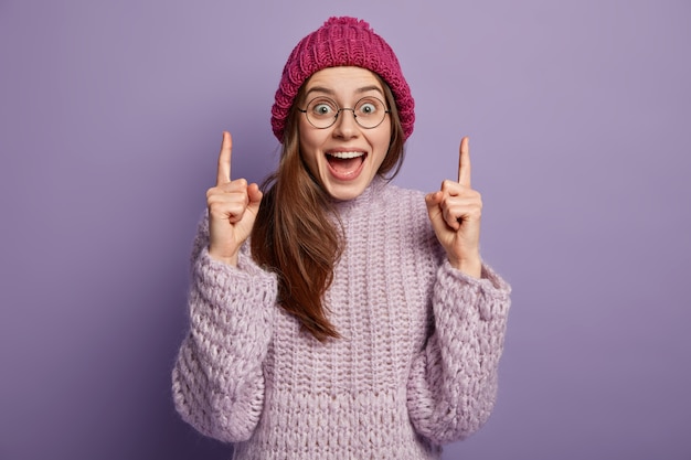 Brunette woman wearing knitted sweater and hat