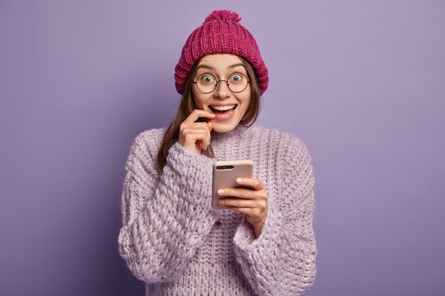 Brunette woman wearing knitted sweater and hat