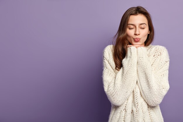 Brunette woman wearing white sweater