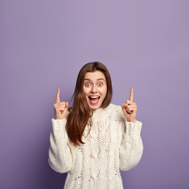 Brunette woman wearing white sweater