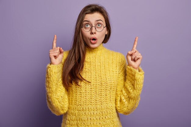 Brunette woman wearing yellow sweater