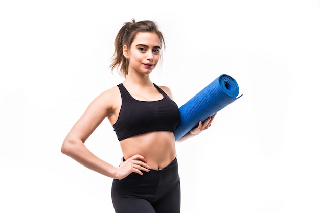 Brunette woman with blue mat in her hands