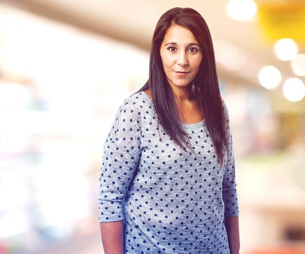 Brunette woman with jumper over blurred background