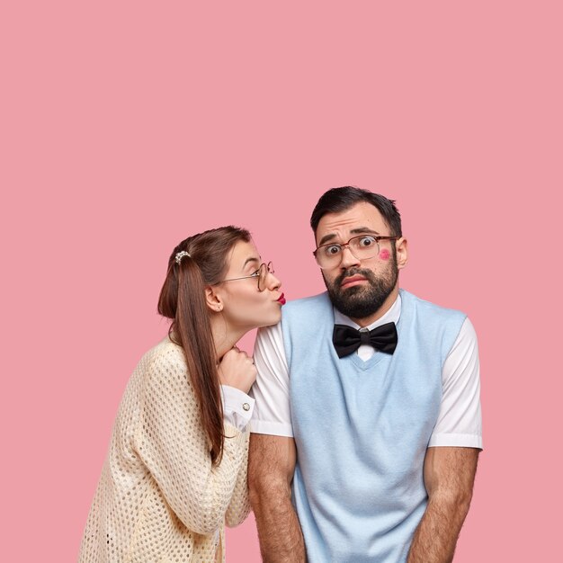 Free photo brunette woman with pigtails and man wearing bowtie and vest