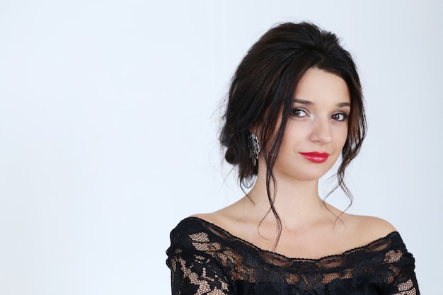 brunette woman with red lipstick and black dress