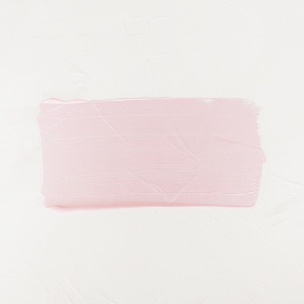 ブラシストロークアクリル絵の具の汚れ。白で隔離されペイントブラシのピンク色のストローク