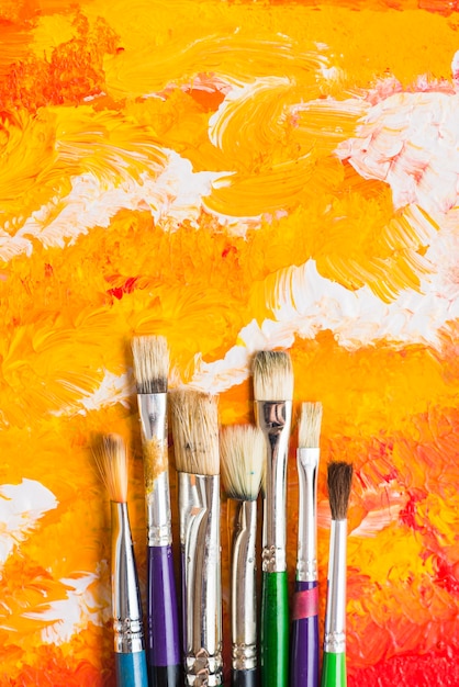 Brushes lying on orange painting