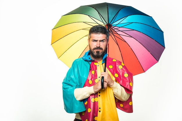 Brutal bearded man with rainbowcolored umbrella isolated on white background rain weather autumn moo... Premium Photo