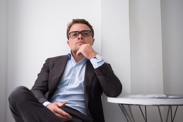 Brutal businessman looking with angry at camera