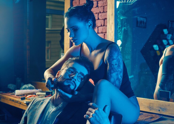 Brutal man in elegant suit and sexy girl with tattoo