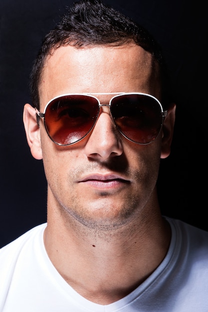 Brutal man wearing sunglasses close up