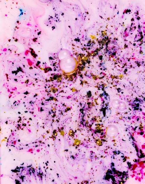 Bubble coming out from the mixed holi color powder on pink surface
