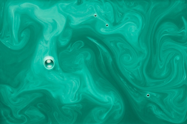 Bubble over the green and white liquid paint background