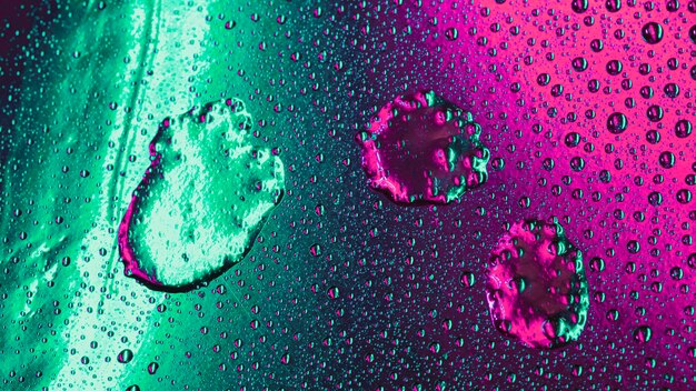 Bubbles pattern on wet green and pink surface backdrop