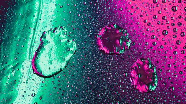 Bubbles pattern on wet green and pink surface backdrop