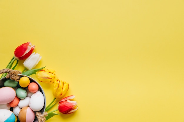 Free photo bucket of eggs and tender tulips