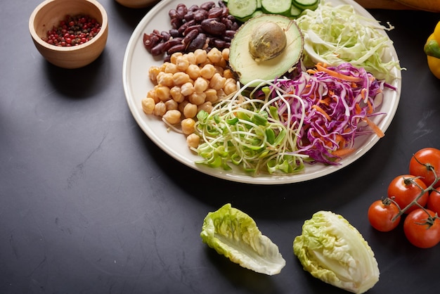 Buddha bowl dish with vegetables and legumes. Top view.