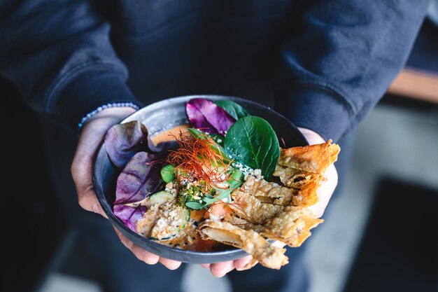 Buddha bowl serving in bowl in hands