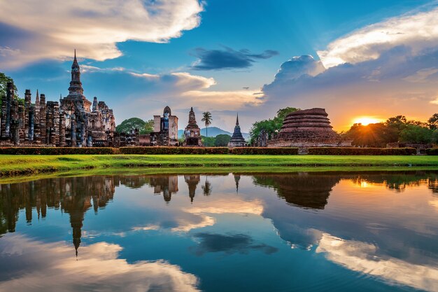 Buddha statue and Wat Mahathat Temple in the precinct of Sukhothai Historical Park