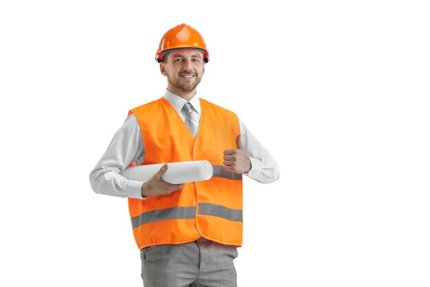 The builder in a construction vest and orange helmet standing on white studio