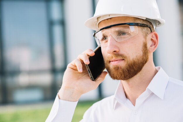 Builder man with smartphone
