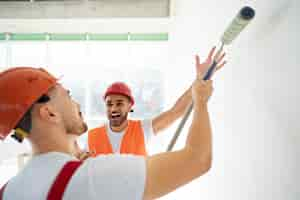 Free photo building and construction workers on the site