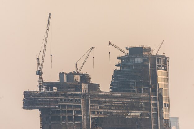 Building costruction of Tall Dubai Marina skyscrapers in UAE