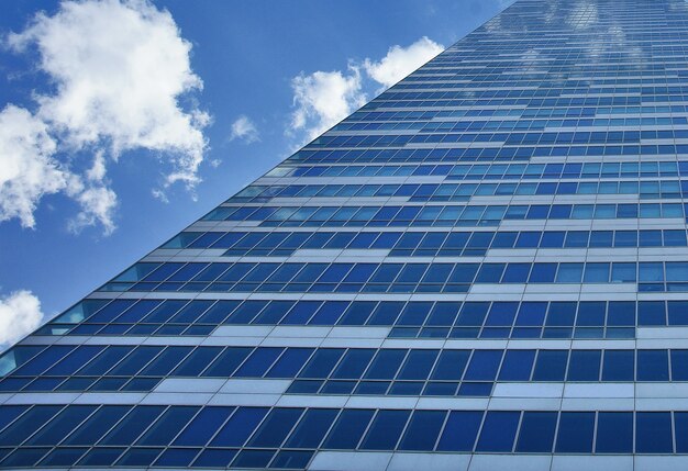 Building of glass windows with sky behind