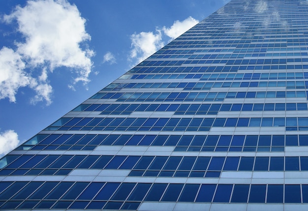 Building of glass windows with sky behind