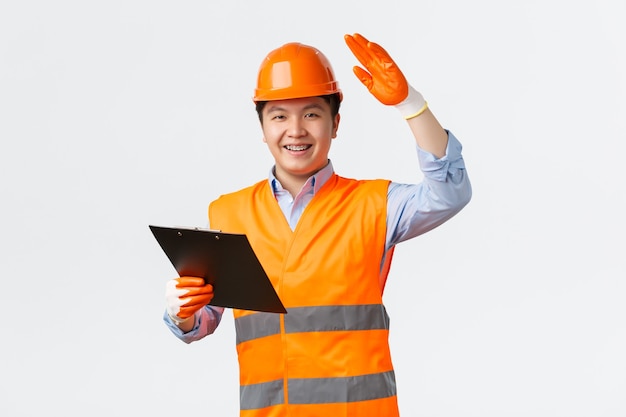 Free photo building sector and industrial workers concept cheerful smiling asian construction manager inspector...