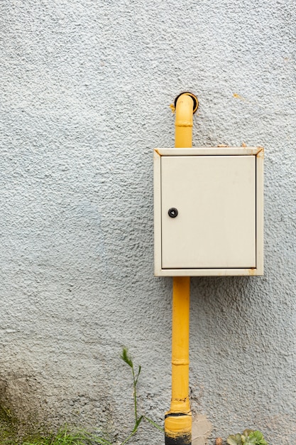 building wall with pipe and box