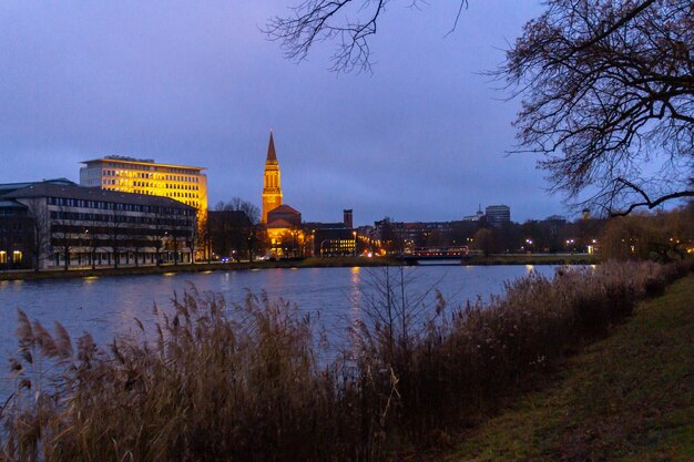 Buildings of a city next to the water at nighttime