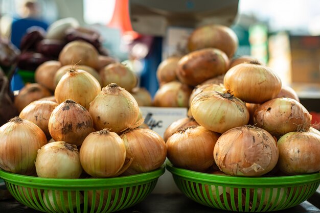 Bulbs of onion in green baskets.