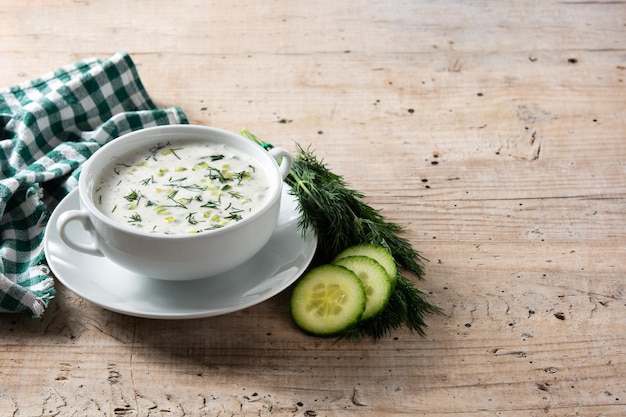 Bulgarian tarator sour milk soup in bowl on wooden table