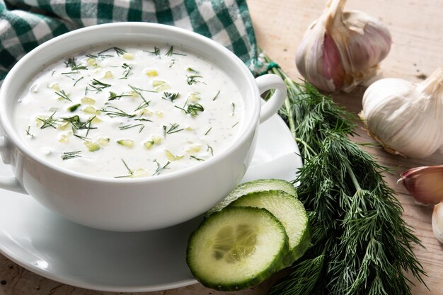 Bulgarian tarator sour milk soup in bowl on wooden table