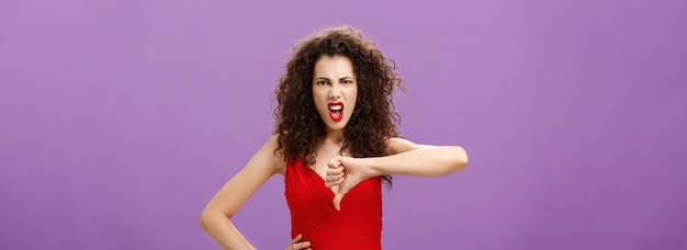 Free photo bullshit i hate your lame ideas displeased and pissed lady boss with curly hairstyle in red evening