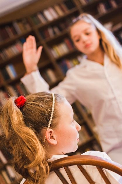 Bully swinging arm to slap little girl